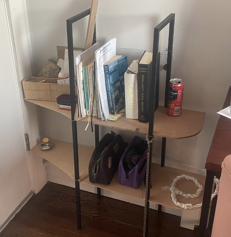 A shelf that fits neatly behind a door in a small room