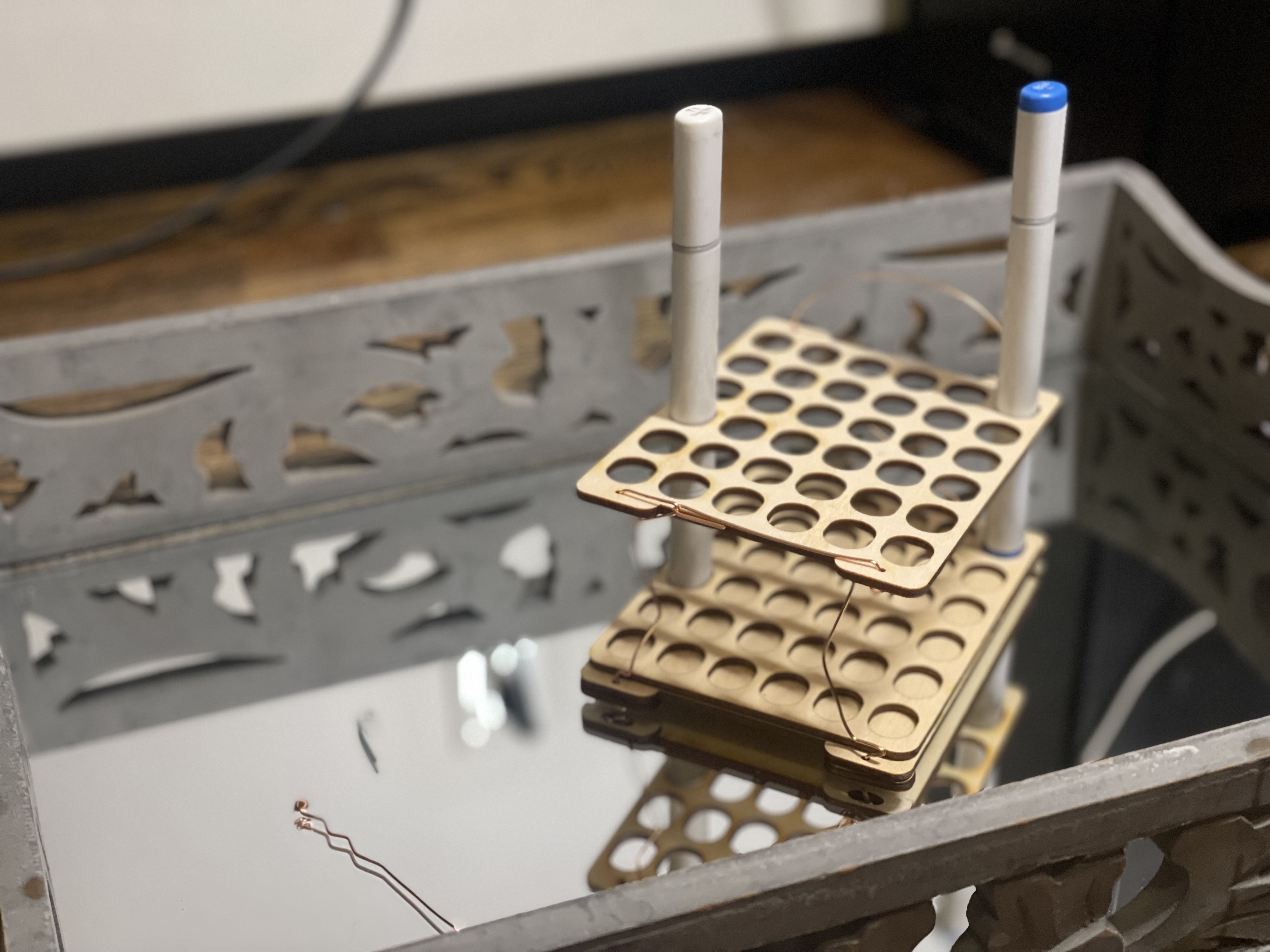 A small holder for copic markers, pictured on a classy mirrored tray