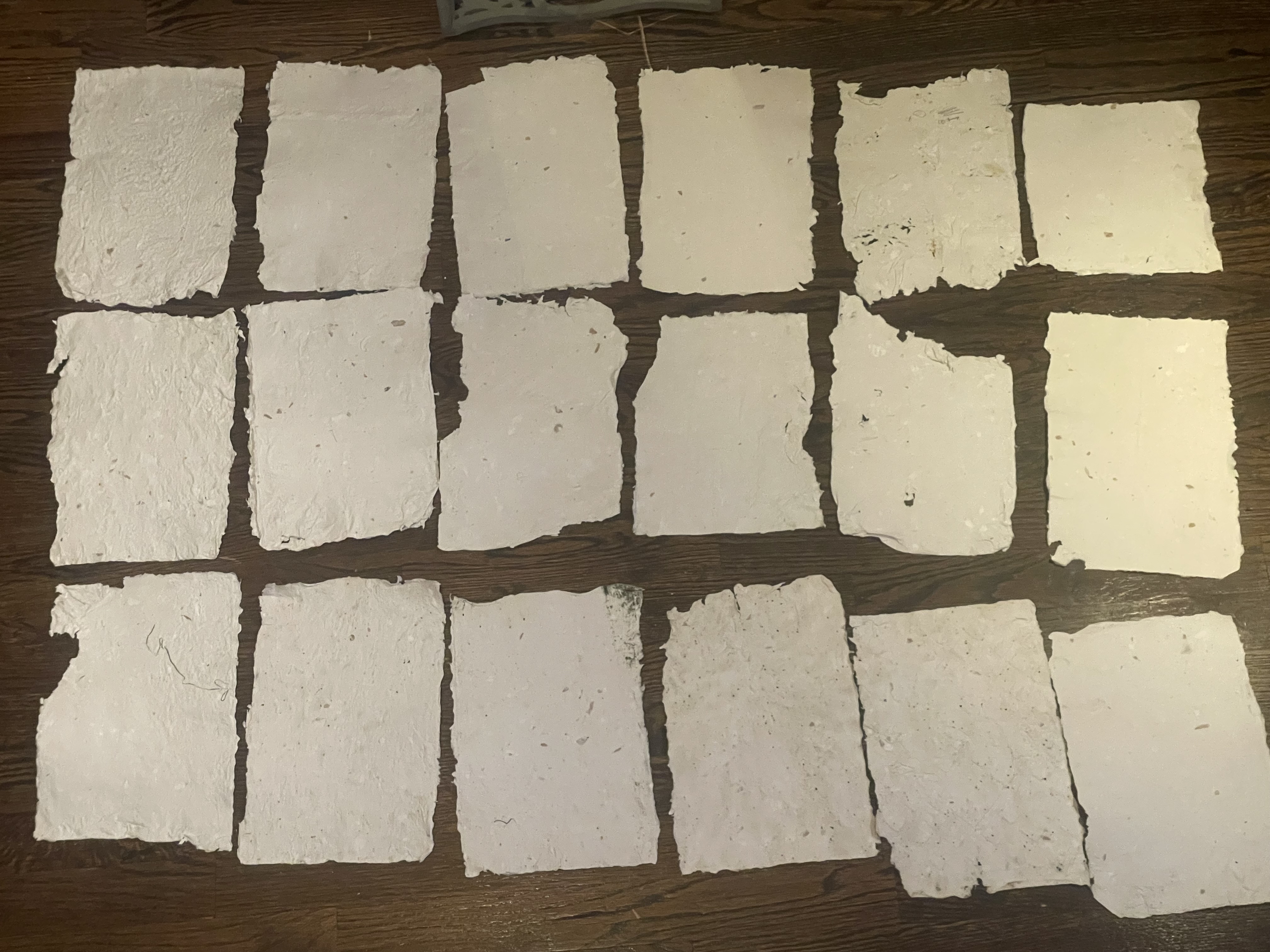 Sheets of recycled paper laid out showing various finishes